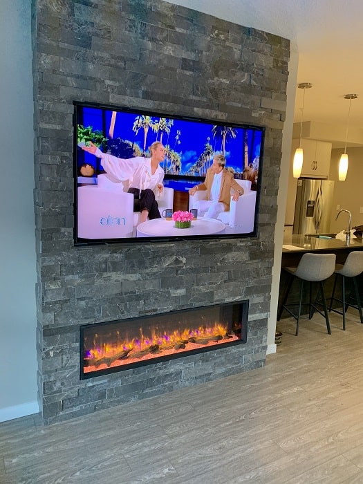 Living room with electric fireplace and big flatscreen TV
